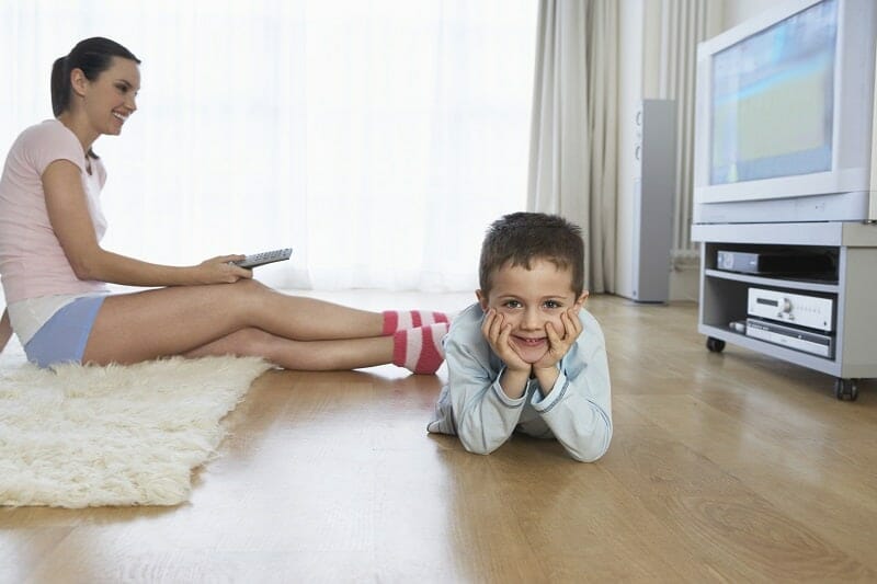 Mother and Son Watching Television in Living Room