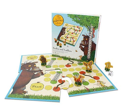 A classic snakes and ladders game with a Gruffalo twist features four stand up Gruffalo characters and a dice.