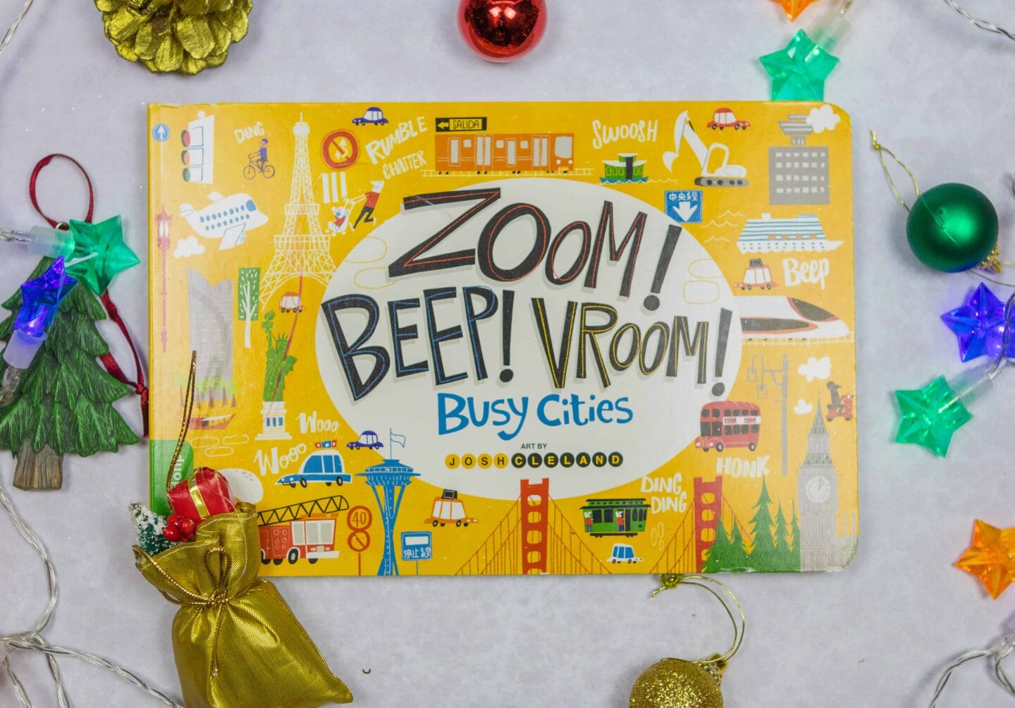 Zoom! Beep! Vroom! Busy Cities, illustrated by Josh Cleland is full of great cities and their sounds. Buses and taxis honking their horns in London whilst a bullet train zooms along in Hong Kong. As you read, little ones can enjoy the noises that this book has to offer in some of the best cities including San Francisco, New York, Vancouver and much more. The vehicles include fire engines, diggers, motorcycles and boats.