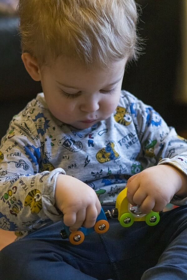 Rex playing with the Hape Rainbow Puzzle Wooden Train Set