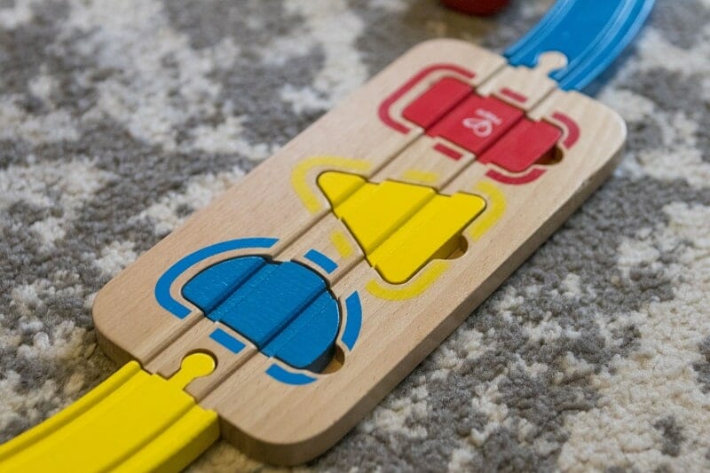 The shape sorter section of track from the Rainbow Puzzle Wooden Train set from Hape