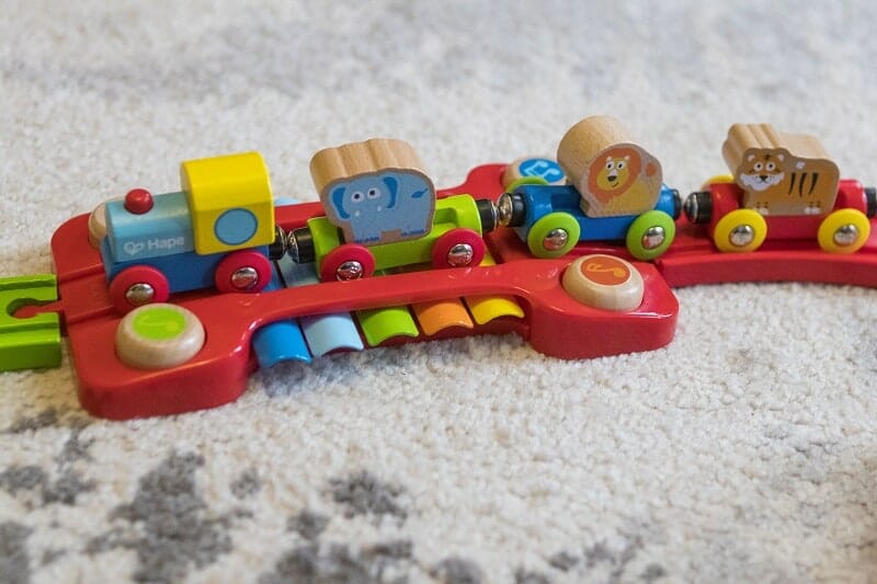 The train, carriages and animals together with the xylophone section of the Rainbow Puzzle Wooden Train set from Hape