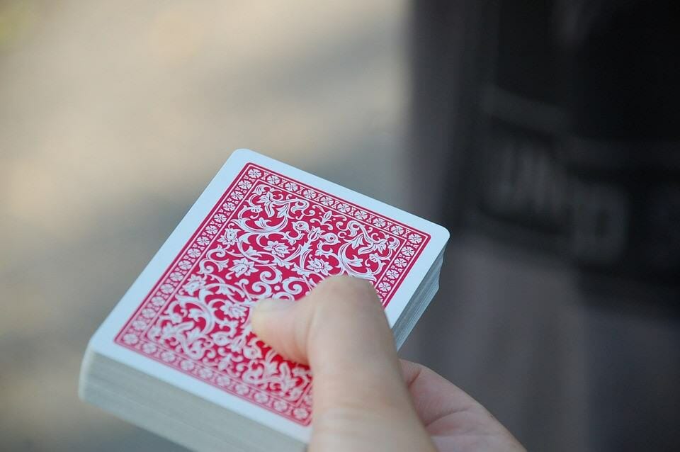 Someone holding a pack of cards