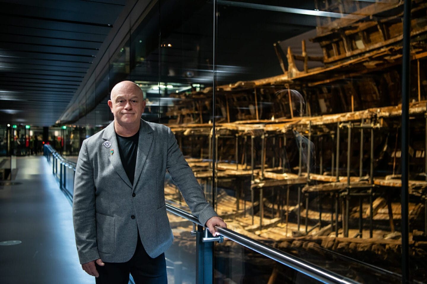 Ross Kemp standing next to the Mary Rose in Portsmouth Harbour