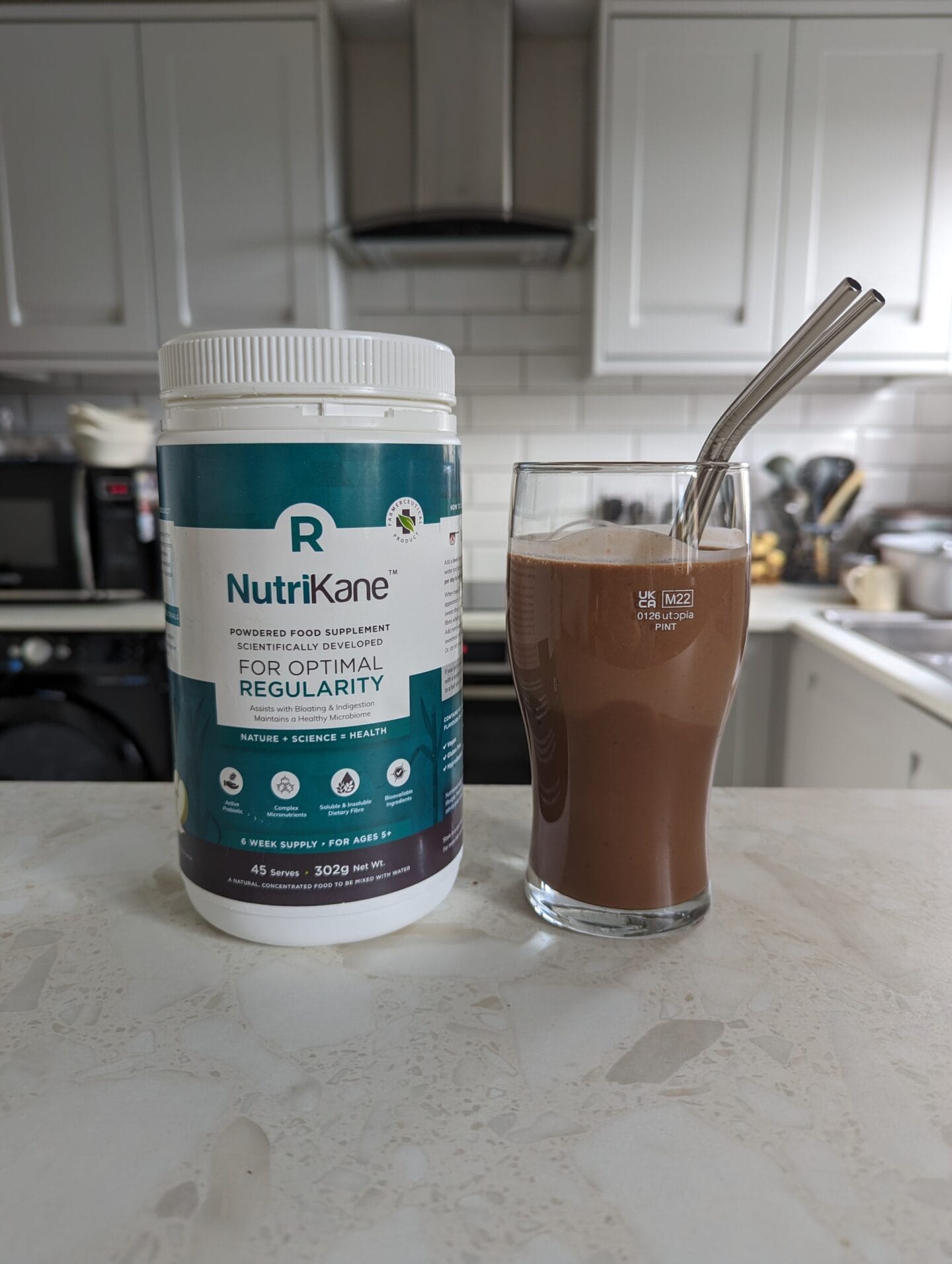 A NutriKane R Optimal Regularity Tub next to a NutriKane Breakfast Snickers Smoothie